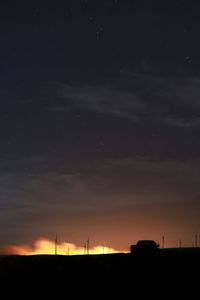 Low angle view of windmill against sky at night