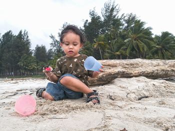 Cute girl playing with ball on land