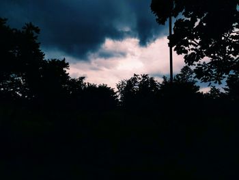 Low angle view of silhouette trees against sky at sunset