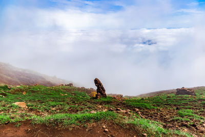 View on precipice hidden in fog and clouds near active volcano aso mount in kyushu, japan