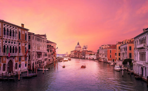 Grand canal amidst buildings in city during sunset