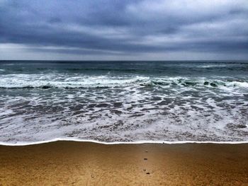 Scenic view of sea against cloudy sky