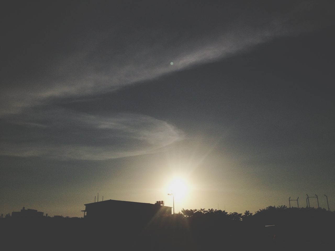 sun, built structure, building exterior, sunset, architecture, silhouette, sky, sunbeam, low angle view, sunlight, cloud - sky, lens flare, house, nature, outdoors, beauty in nature, no people, cloud, building, scenics