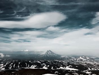 Aerial view of snowcapped mountain against cloudy sky