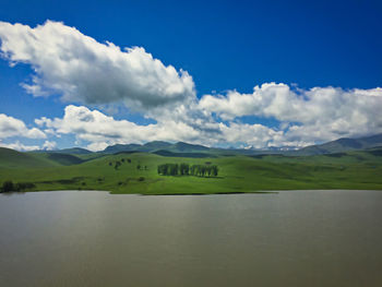 Scenic view of lake and mountains against sky