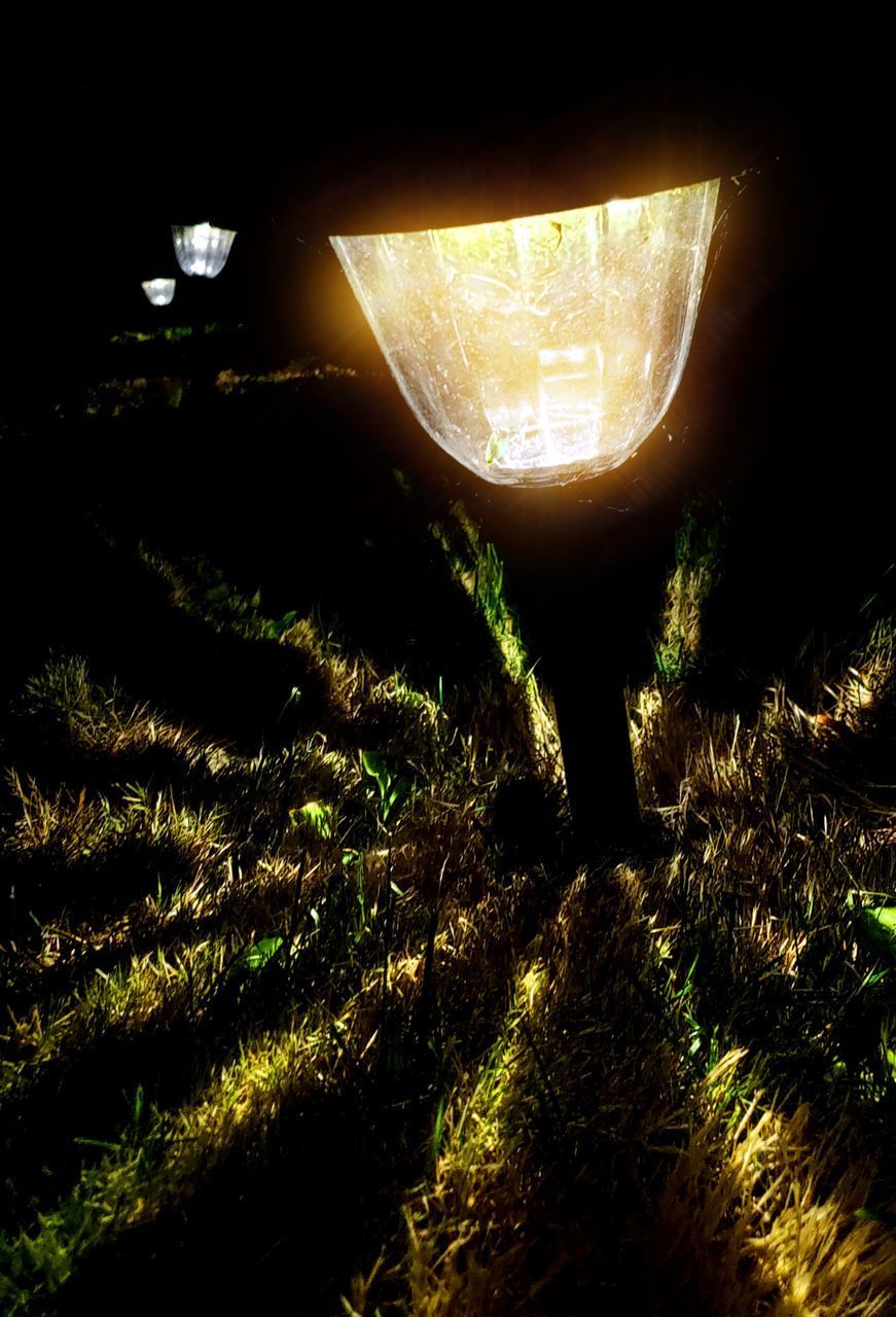 VIEW OF ILLUMINATED LIGHTS ON FIELD AT NIGHT