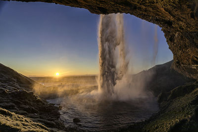 Scenic view of rock formation against sky during sunset