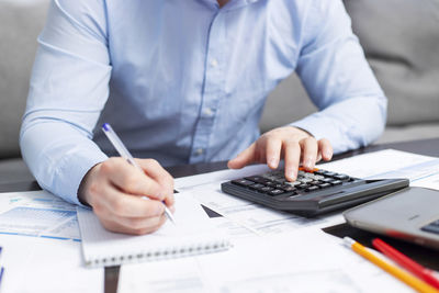 Midsection of man using laptop