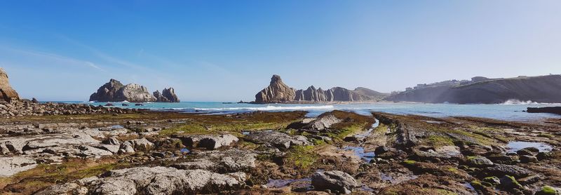 Panoramic view of beach against blue sky