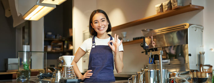 Portrait of young woman using mobile phone at home