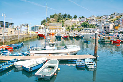 Boats moored at harbor in city