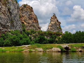 Scenic view of rock formation in lake against sky