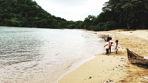 People on beach by sea