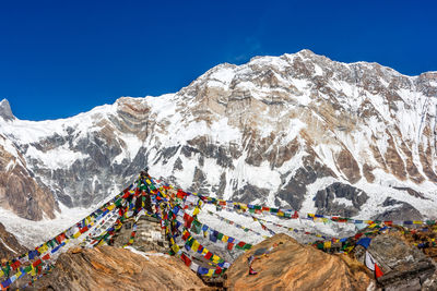 Scenic view of snowcapped mountain against blue sky