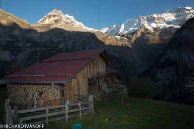 Houses on snowcapped mountains against sky