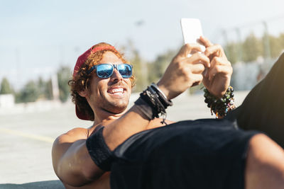 Portrait of smiling young man using mobile phone