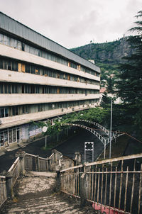 Staircase of building in city against sky