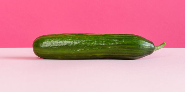 Close-up of green pepper against colored background