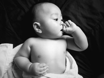 Directly above shot on topless new born baby boy lying on bed