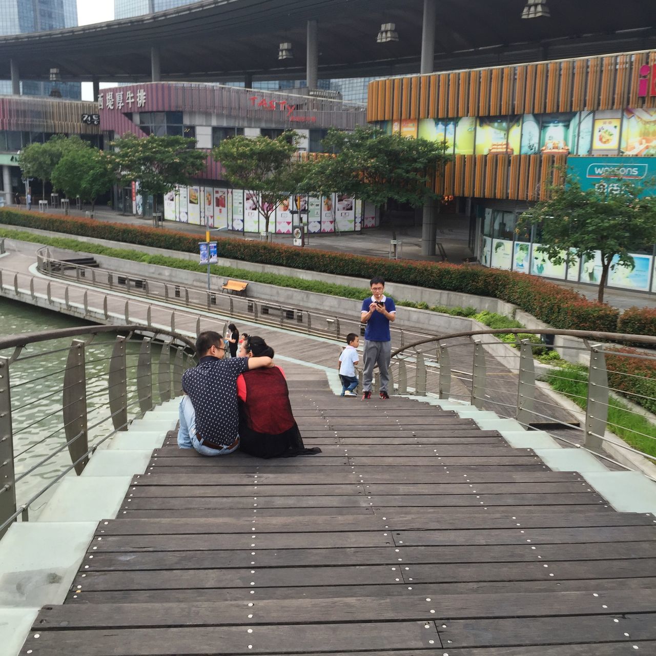 architecture, built structure, rear view, building exterior, lifestyles, men, the way forward, person, walking, full length, leisure activity, city, railing, footpath, city life, togetherness, walkway