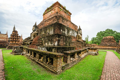 Temple by building against sky