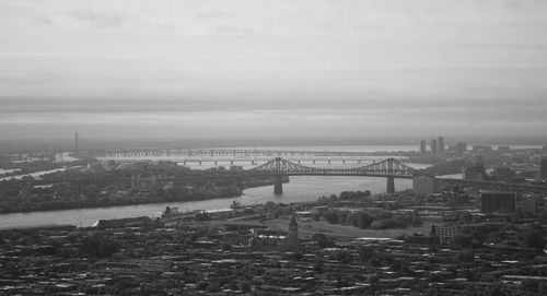 High angle view of bridge over river by buildings in city