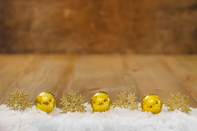 Yellow marbles on snow over table