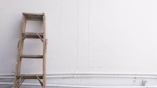 Low angle view of ladder on white wall