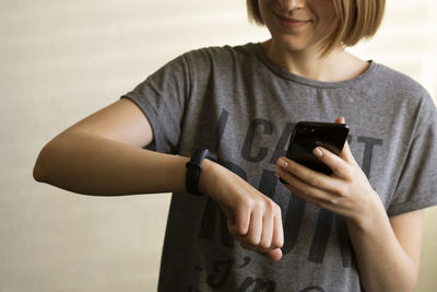 Midsection of man using mobile phone