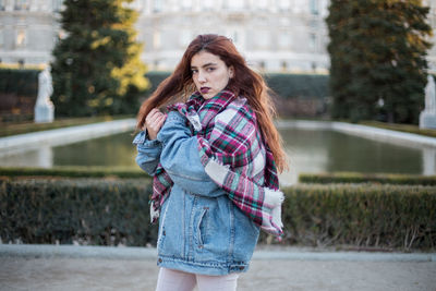 Portrait of beautiful young woman standing outdoors