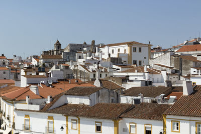 Houses in town against clear sky