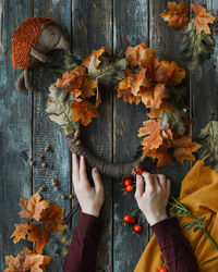 Midsection of woman holding autumn leaves