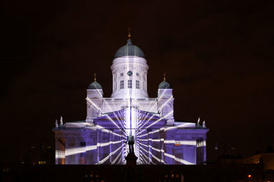 Low angle view of illuminated building against sky at night