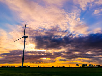 Scenic view of silhouette field against sky during sunset