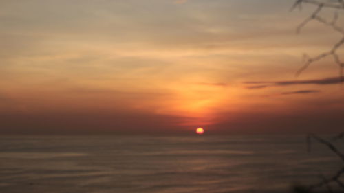 Scenic view of sea against romantic sky at sunset