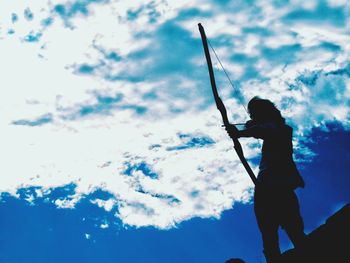 Low angle view of silhouette man standing against sky