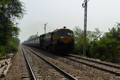 Train on railroad track against sky