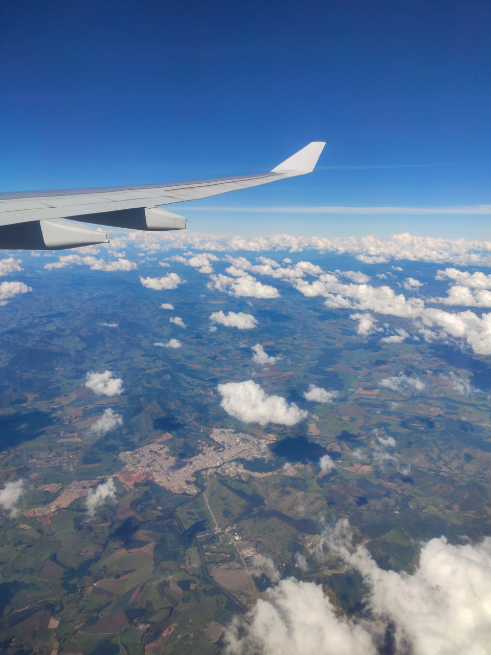 airplane, air vehicle, aerial view, flying, sky, aircraft wing, transportation, mode of transportation, travel, environment, nature, aerial photography, blue, cloud, mid-air, scenics - nature, no people, landscape, vehicle, aircraft, journey, day, air travel, beauty in nature, on the move, outdoors, horizon, wing, high up, motion, travel destinations, aviation, cloudscape, land