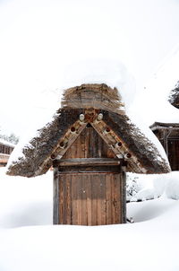 Close-up of house against clear sky during winter