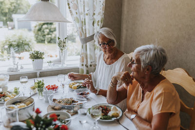 Senior women having meal together and talking