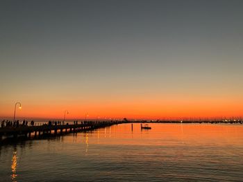 Scenic view of sea against clear sky during sunset