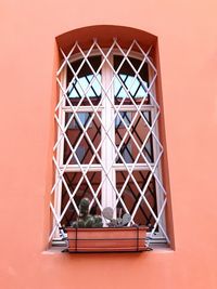 Low angle view of window on building with terracotta wall 