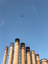 Low angle view of kites against blue sky