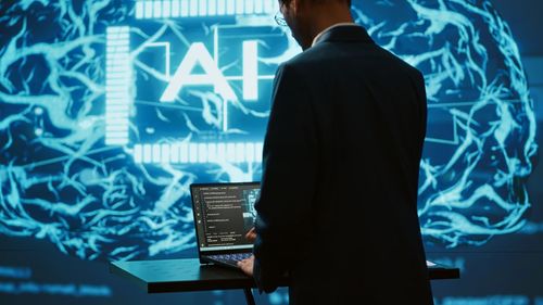 Rear view of businessman using mobile phone