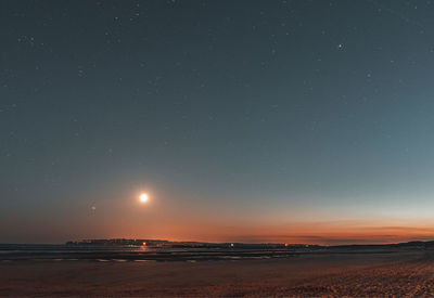 Scenic view of sea against sky at night