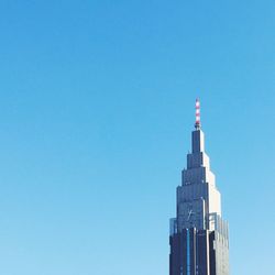 Low angle view of tower against clear blue sky
