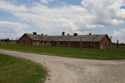 Houses by road against sky