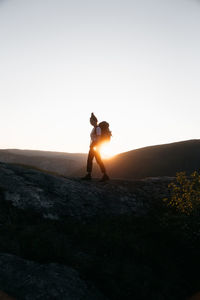 Rear view of woman standing on mountain