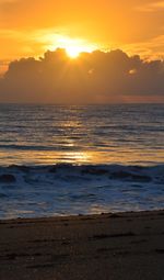 Scenic view of sea against sunset sky