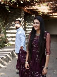 Portrait of young couple standing outdoors